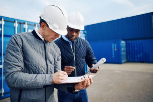 two-engineers-standing-in-a-shipping-yard
